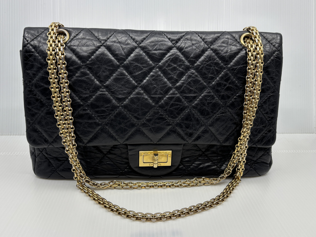 Chanel Reissue 2.55 Double Flap in black aged calfskin with gold-tone chain, front view
