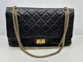 Chanel Reissue 2.55 Double Flap in black aged calfskin with gold-tone chain, front view