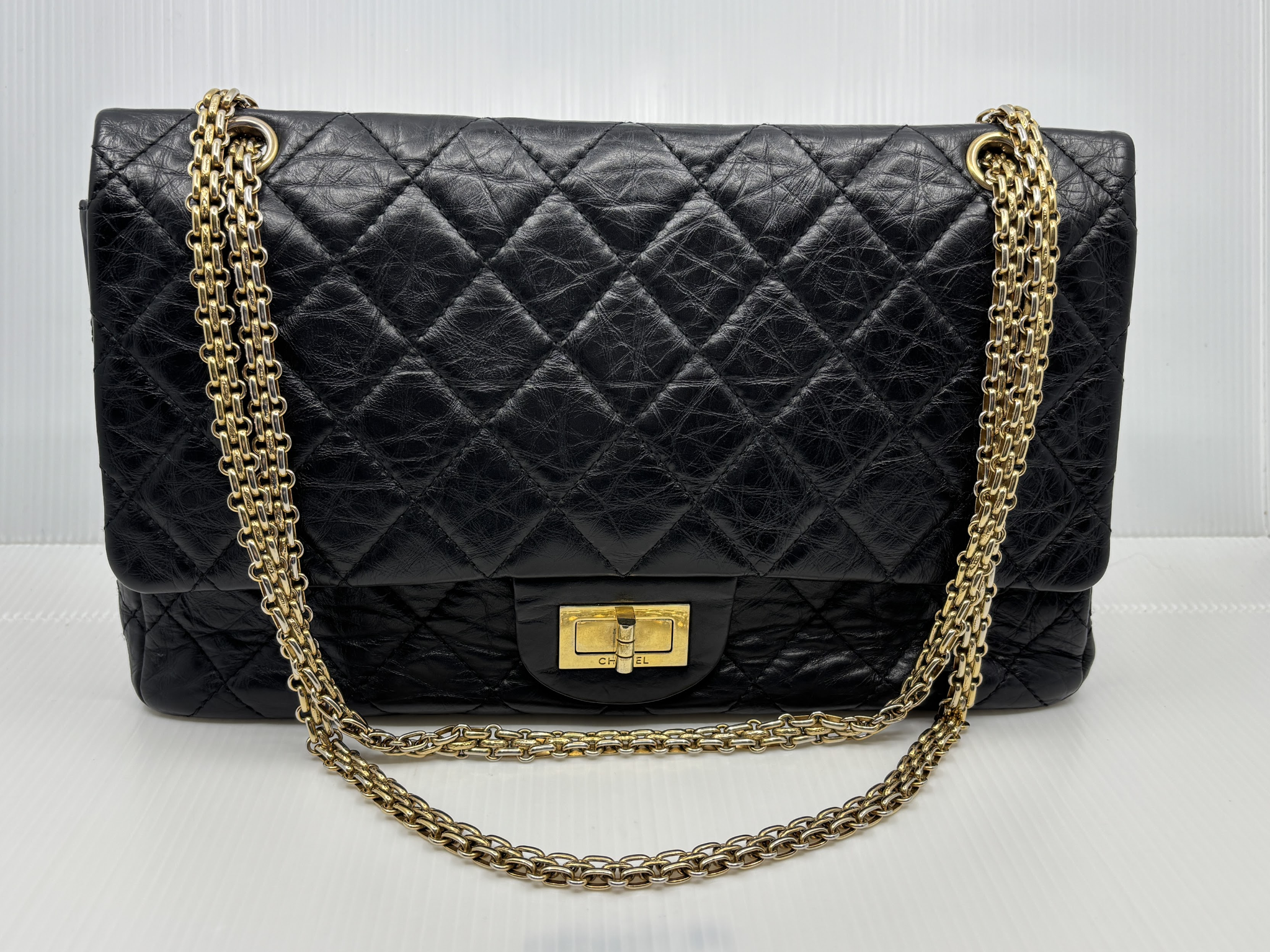 Chanel Reissue 2.55 Double Flap in black aged calfskin with gold-tone chain, front view