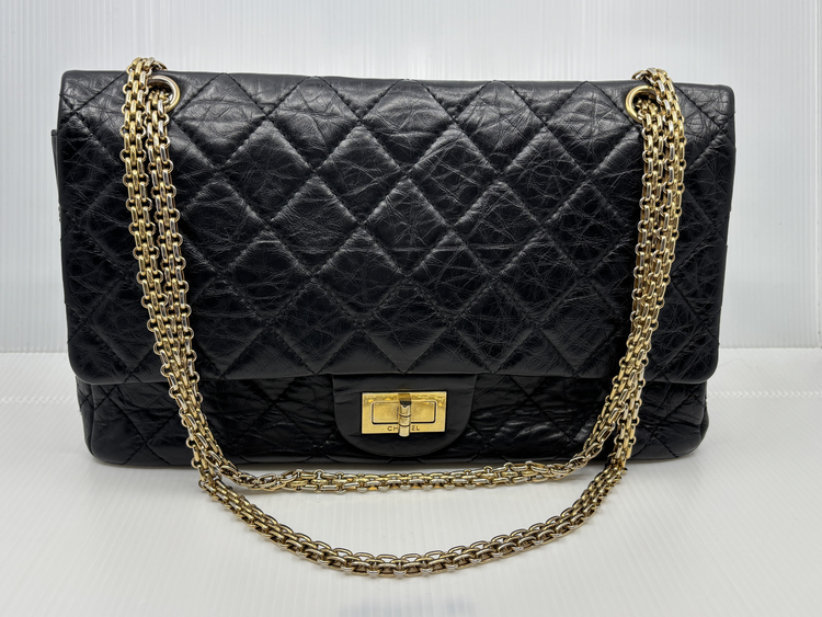 Chanel Reissue 2.55 Double Flap in black aged calfskin with gold-tone chain, front view